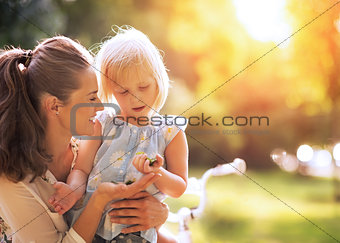 Mother and baby girl having fun outdoors