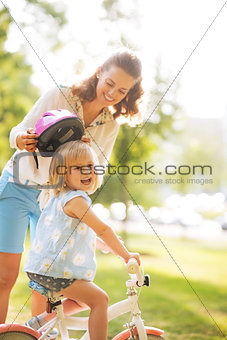 Mother and baby girl riding on bicycle