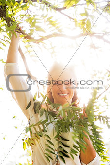 Portrait of smiling young woman in foliage