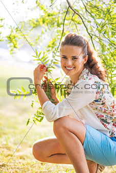 Portrait of smiling young woman in foliage