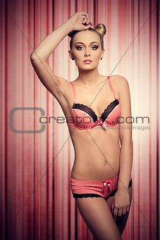 charming woman in pink lingerie in vintage color