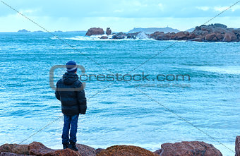Boy and Tregastel coast view (Brittany, France)