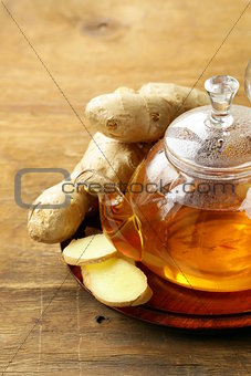 beverage tea with ginger and fresh root on a wooden background