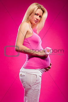 Pregnant young woman with flower