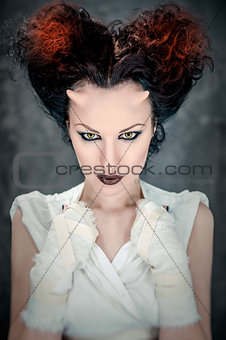 Portrait of beautiful horned woman with bright makeup