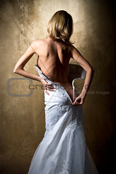 Lovely sensual bride unzip her wedding dress