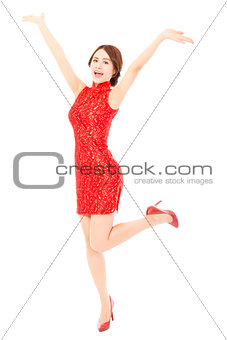 happy asian young woman with cheongsam raising hands . 