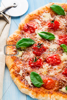 Pizza with cherry tomatoes and basil