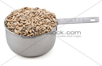 Hulled sunflower seeds in a cup measure