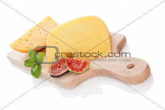 Cheese variaton on chopping board isolated.