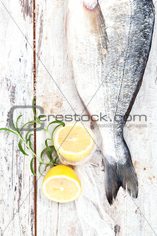 Seafood. Fish with lemon and herbs, top view.