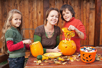 Kids carving jack-o-lanterns for Halloween