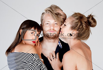 Two Young Female Friends Embracing a Man - 