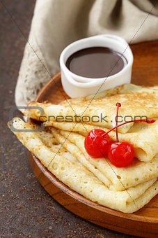 thin pancakes with chocolate sauce on a plate