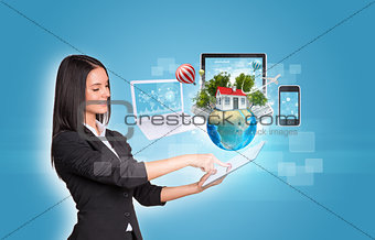Women using digital tablet and Earth with electronics