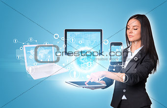Women using digital tablet and Earth with electronics