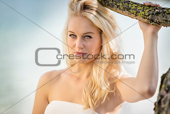 Blond woman under tree