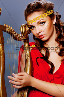 beautiful young girl playing the harp