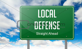 Local Defense on Highway Signpost.