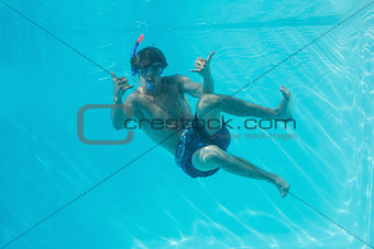 Young man wearing snorkel underwater