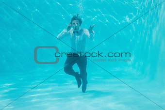 Young man swimming underwater