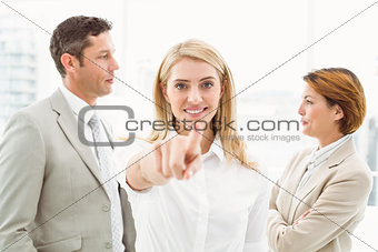 Businesswoman pointing at you with colleagues in office