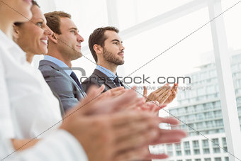 Business people clapping hands in office