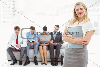 Businesswoman against people waiting for interview