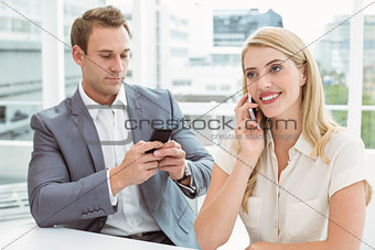Business people using mobile phones