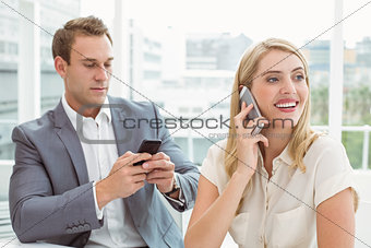 Business people using mobile phones