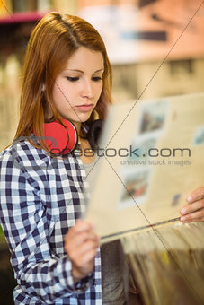 Redhead with check shirt holding a vinyl