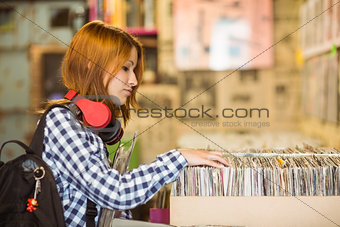 Pretty redhead searching a vinyl