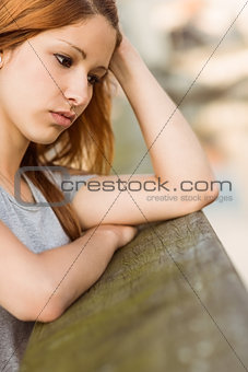 Sad redhead thinking about her life