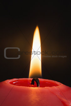 Close up of a red candle burning
