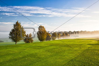 On the empty golf course in the morning mist
