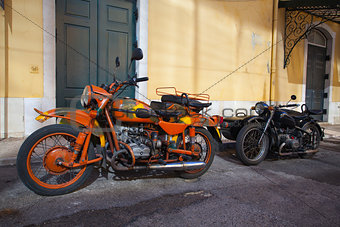Two historic motorcycle with sidecar on a street