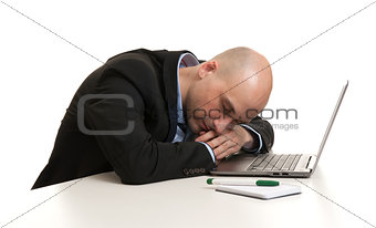 Tired businessman sleeping at work place