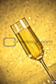 tilted flute of golden champagne