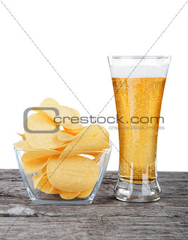 Glass of Fresh Beer and bowl of with Pile potato chips on a whit