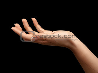 Female hand with open palm over black background