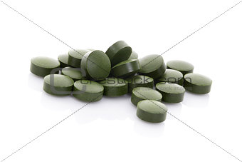 Green pills isolated on white background.