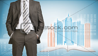 Businessman and wire-frame buildings on open book