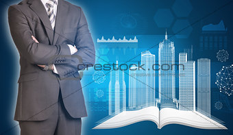 Businessman and wire-frame buildings on open empty book