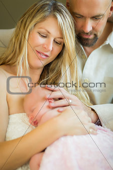 Beautiful Young Couple Holding Their Newborn Baby Girl