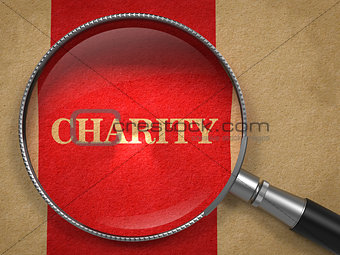 Charity through Magnifying Glass on Old Paper.