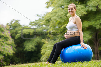 pregnant woman belly swiss fit ball workout park