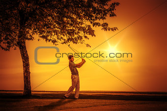 golf player sunset