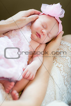 Hands of Mother Holding Her Newborn Baby Girl
