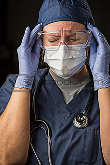 Grimacing Female Doctor or Nurse Wearing Protective Wear