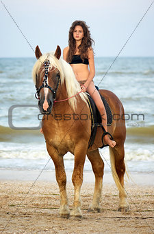 teen girl riding a horse